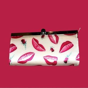Angel brand cream colored clutch with lip print and roses design! New!